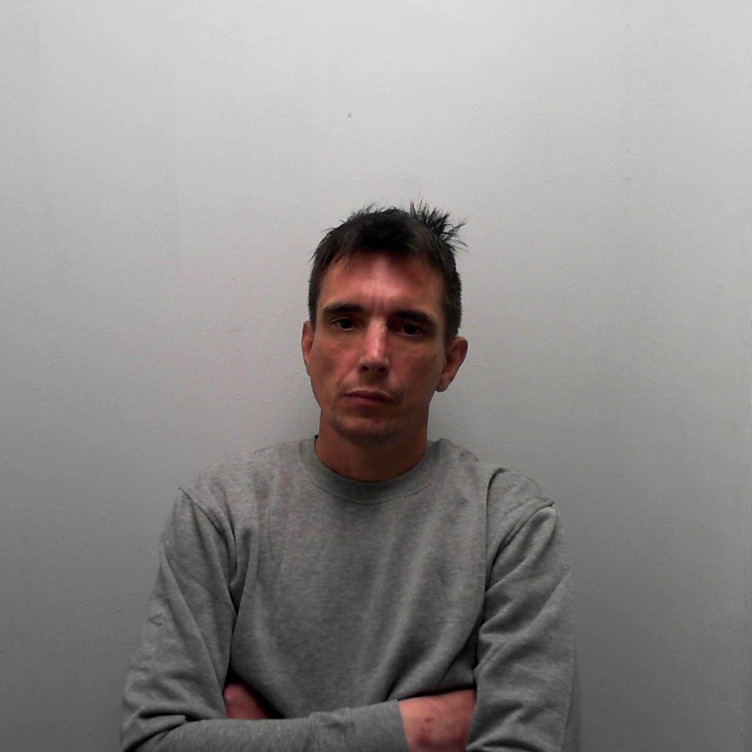Hunt for violent thug on way back to jail